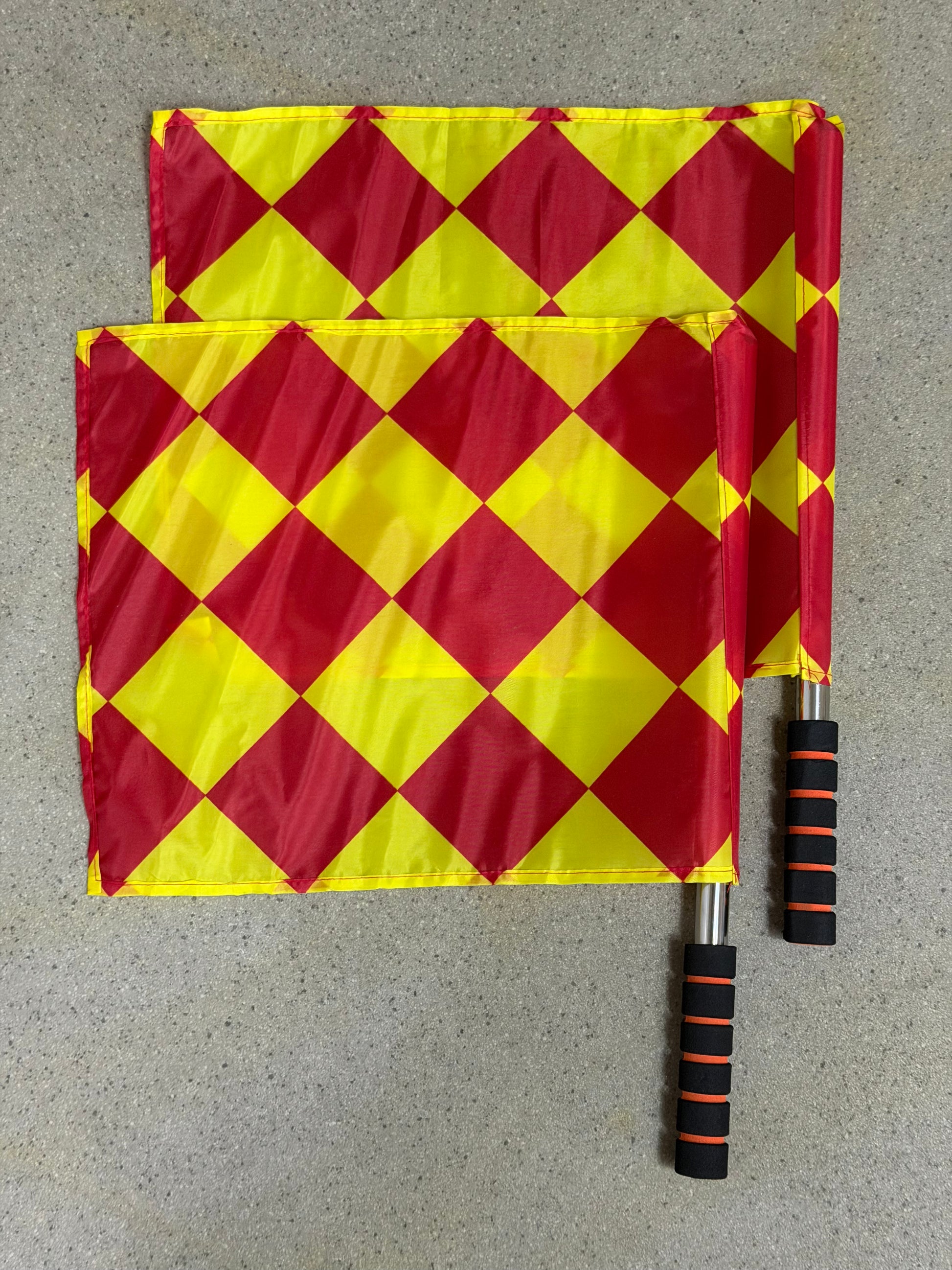 Soccer referee essential set with red and yellow checkered flags and black handles